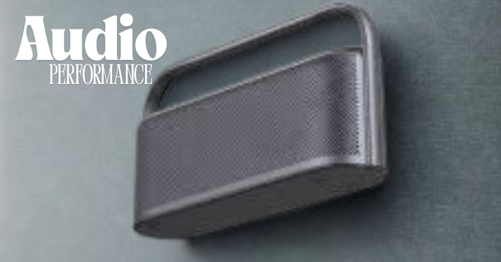 Close-up of speaker control buttons and volume dial