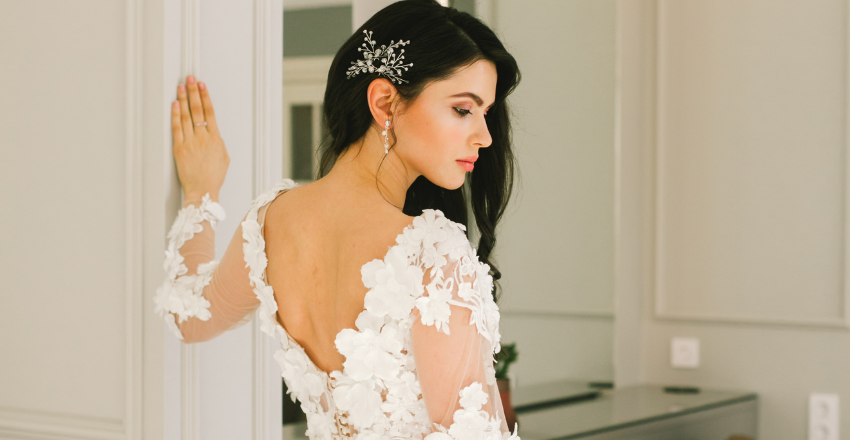 Back view of a sleek sheath wedding gown with covered buttons