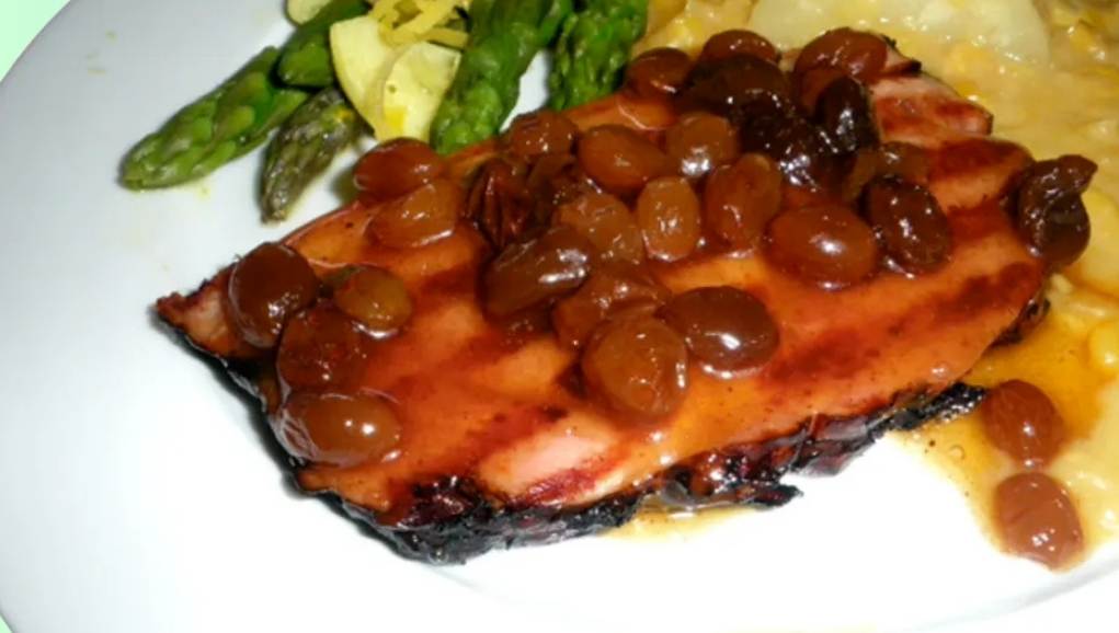 Close-up of a glossy raisin glaze in a serving dish