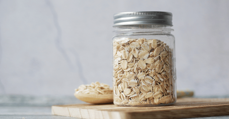 Bowl of dry rolled oats on a kitchen counter
